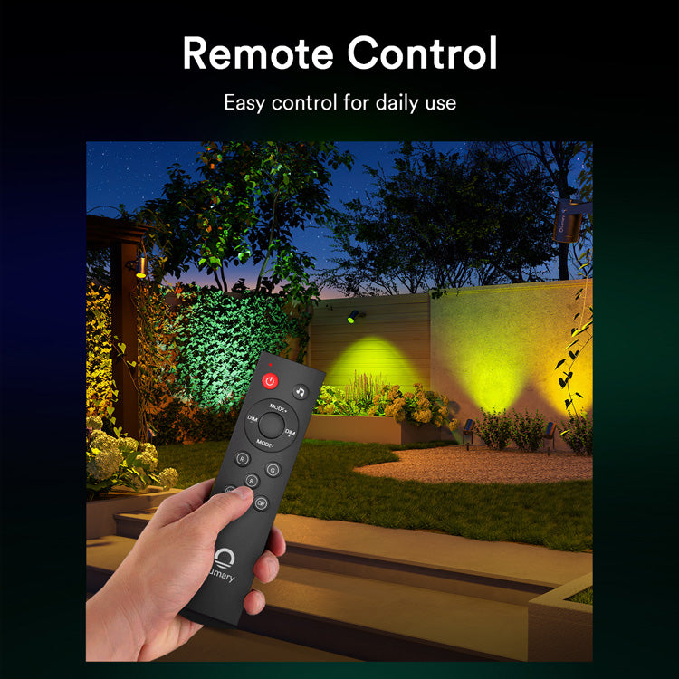 Hand holding Lumary remote control for outdoor lights in yard.